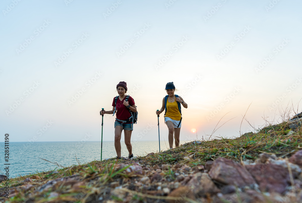 Two young Asian female hipster hiking on mountain holiday, wild adventure. Background for Travel concept