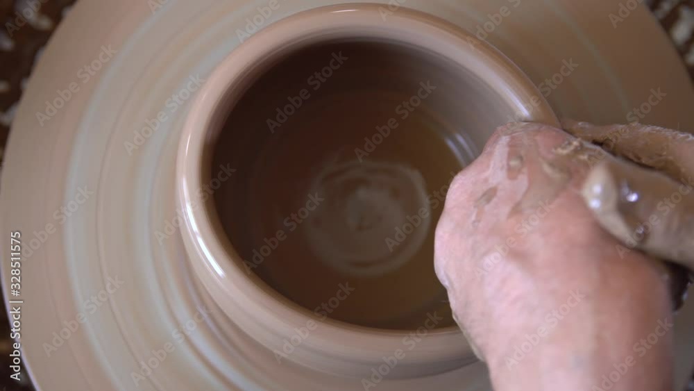 Process of manufacturing clay crockery by potter in potery workshop. Process of manufacturing clay crockery by potter in potery workshop.
