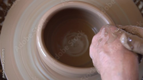 Process of manufacturing clay crockery by potter in potery workshop. photo