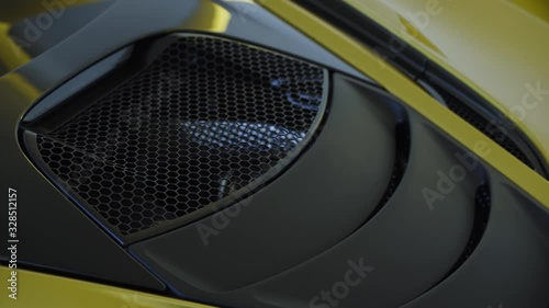 Modern yellow supercar engine bay hood with air intake 