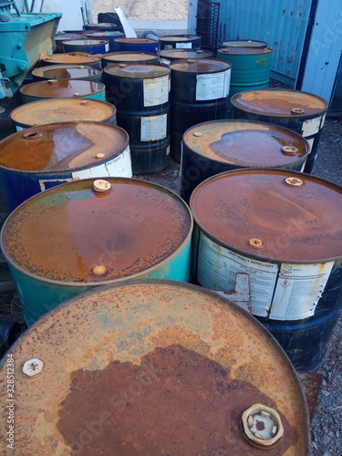 rusty barrels in a scrap metal dump