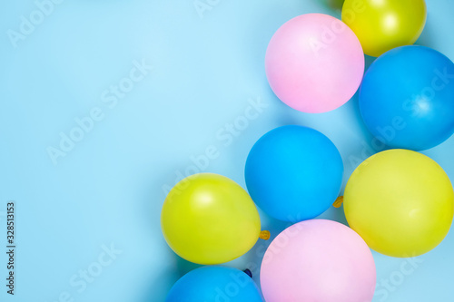 Сolorful balloons on blue background with copy space.
