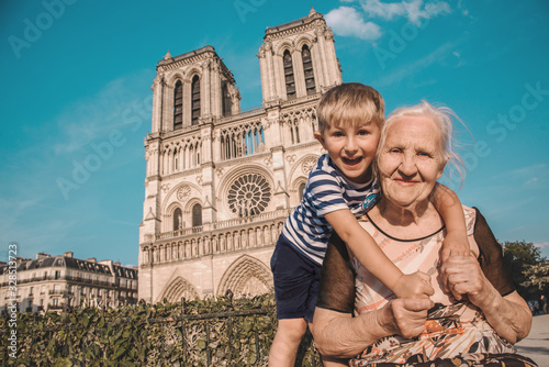 Elderly woman with grandson walking in Paris