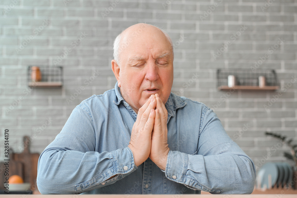 Portrait of praying elderly man at home Portrait of praying elderly man at home