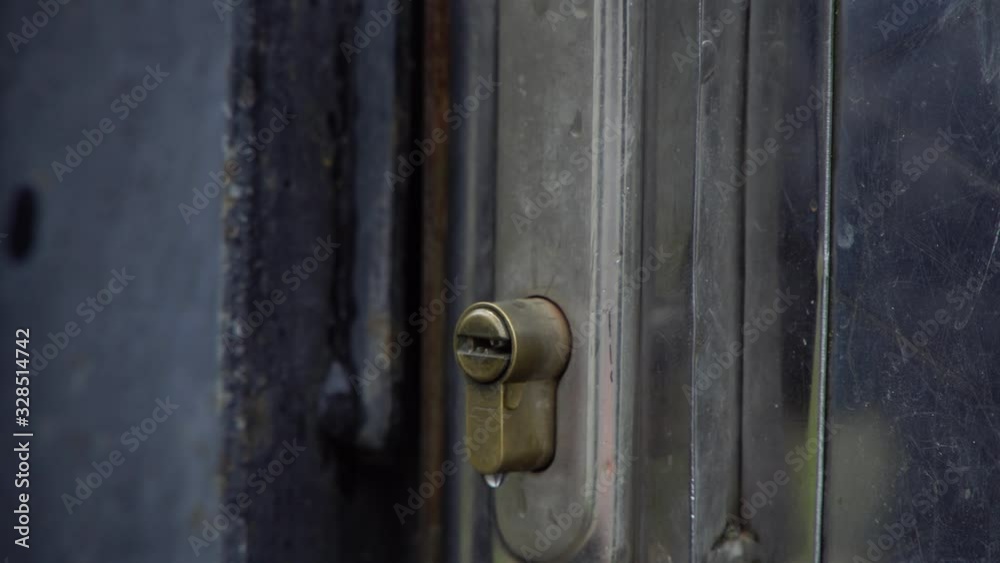The girl puts the key in the lock and turns the key The girl puts the key in the lock and turns the key
