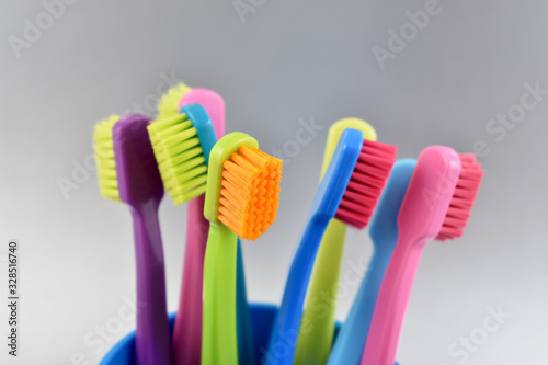 Different multi-colored toothbrushes stock images. Morning hygiene concept. Bathroom accessories images. Toothbrush on a silver background. Toothbrush on a light background with copy space for text