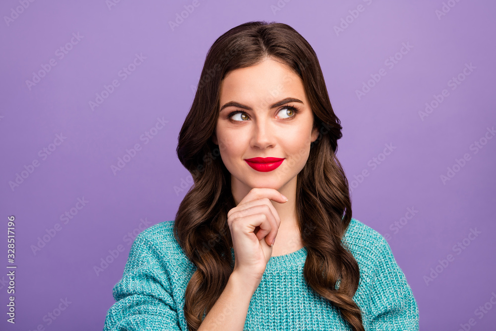 Closeup photo of pretty curly lady red lips good mood look dreamy up empty space hold arm on chin tricky person wear blue warm sweater isolated purple color background Closeup photo of pretty curly lady red lips good mood look dreamy up empty space hold arm on chin tricky person wear blue warm sweater isolated purple color background