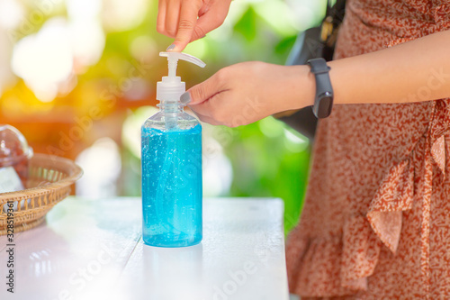 People cleaning hand using alcohol gel hand sanitizer cleaners for anti becteria and protect from Coronavirus Disease 2019 (COVID-19) virus outbreaks. photo