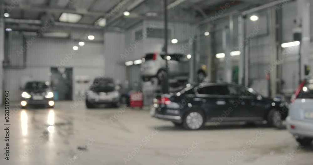 Car Service Station With Vehicles. Real Working Day. Blurred Background Car Service Station With Vehicles. Real Working Day. Blurred Background