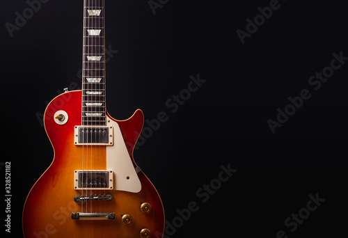 Fototapeta Vintage electric guitar on black background