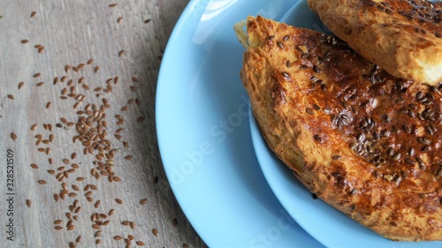 Wallpaper Mural oriental bread on a blue dish and linen seeds on a wooden background Torontodigital.ca