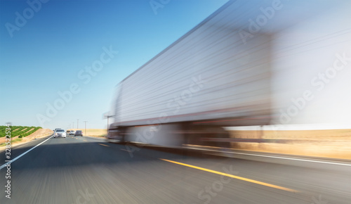 Blurred truck on road. Truckig - transportation theme - background.
