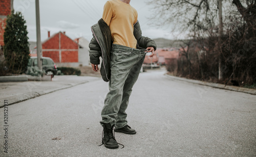 Fotografie Teenager posing on the streets in baggy jeans, stylish outfit