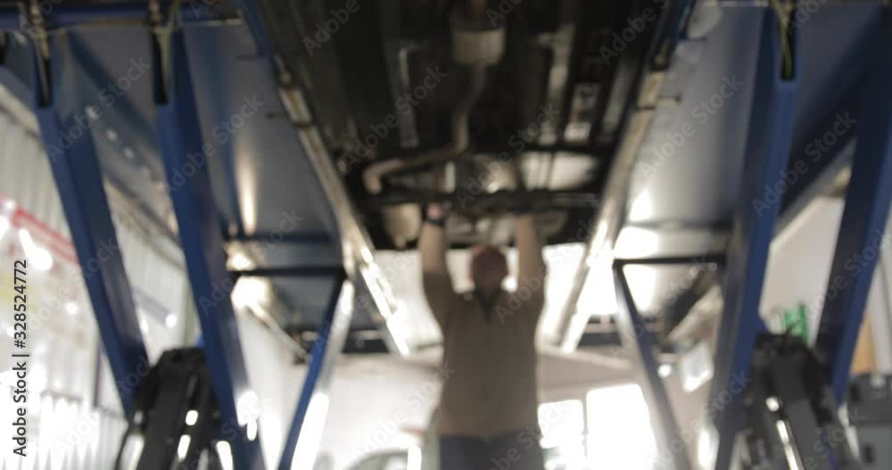 Blurry Background. Man Mechanic Fixing Issues. Blurry Background. Man Mechanic Fixing Issues.