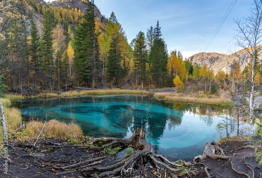 Blue geyser lake in the mountains