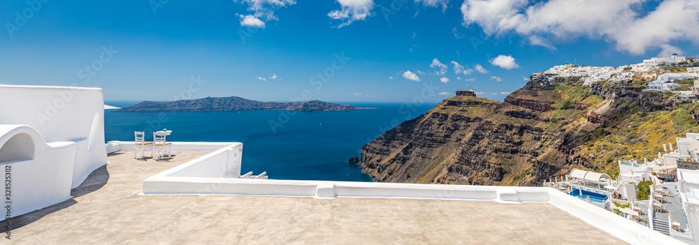 Panoramic travel landscape two chairs on the terrace with sea views. Santorini island, Greece. Travel and vacation background. Best in travel landscape for romantic couple or honeymoon destination. Fa