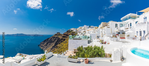 Beautiful panoramic landscape of Santorini island, Oia luxury resort and blue sea sea view with white architecture. Famous travel destination, amazing scenery with pools and luxurious Europe tourism