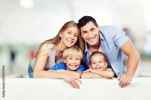 Beautiful smiling family in a room on the couch