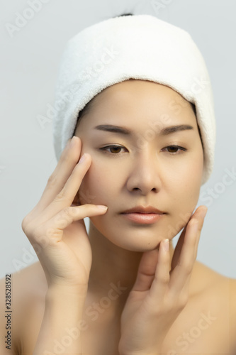Beautiful  woman wrap hair with towel for beauty face care.