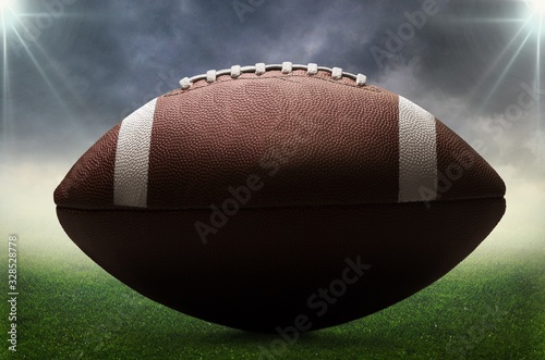 American football ball at an empty stadium