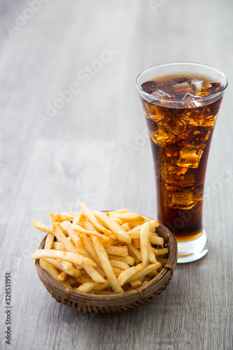a bucket of french fried with soft drink
