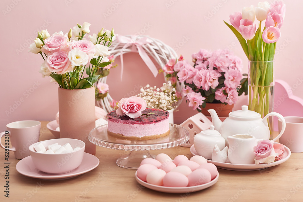 Easter table setting with cake,eggs and flowers. Happy Easter Greeting Card Template. Easter cake and colorful eggs on festive table. The concept of family celebration. Easter holiday. Easter table setting with cake,eggs and flowers. Happy Easter Greeting Card Template. Easter cake and colorful eggs on festive table. The concept of family celebration. Easter holiday.