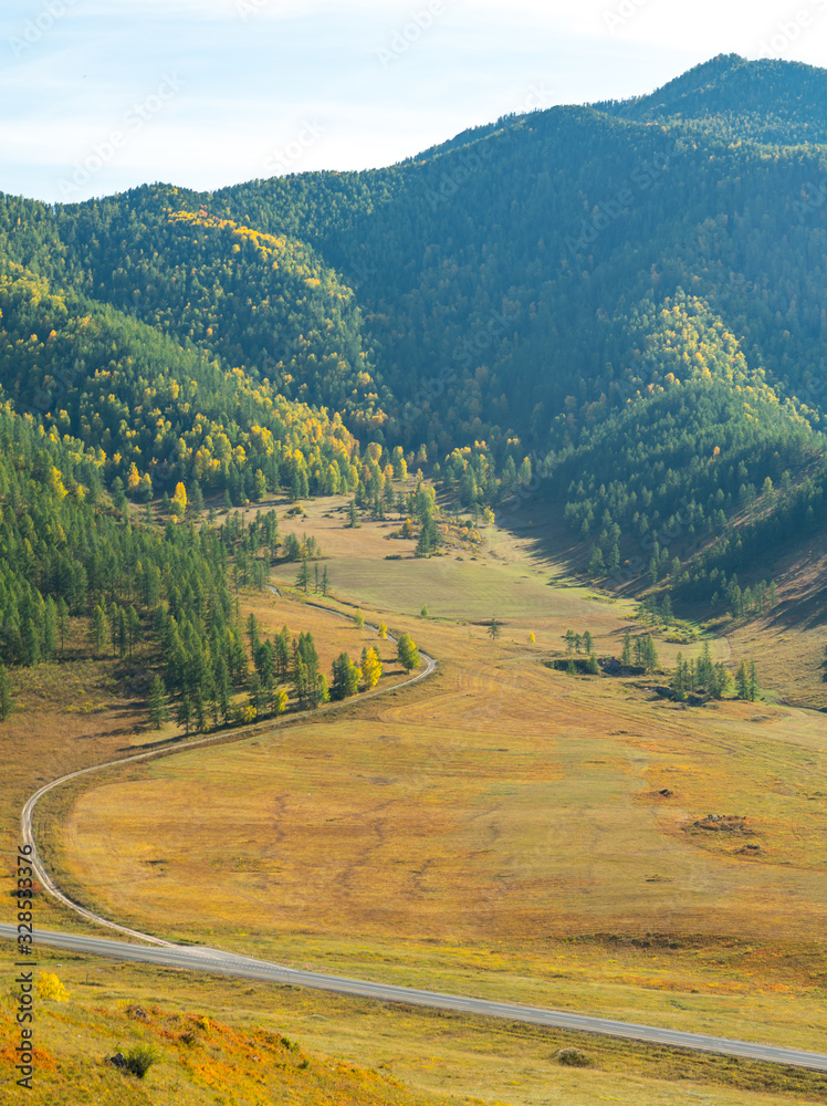 Fototapeta premium Beautiful road among autumn mountains