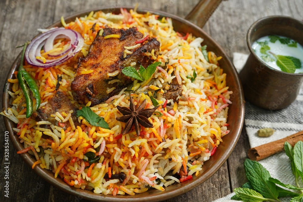 Homemade Fish Biryani served with yogurt Raita Salad, selective focus Homemade Fish Biryani served with yogurt Raita Salad, selective focus