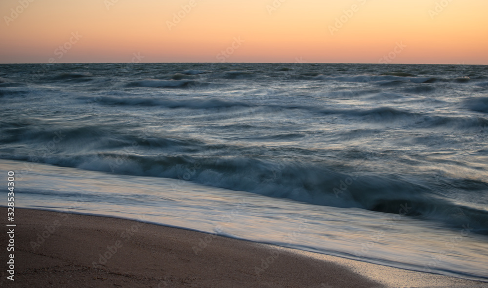 Fascinating sea waves splash along the sandy beach