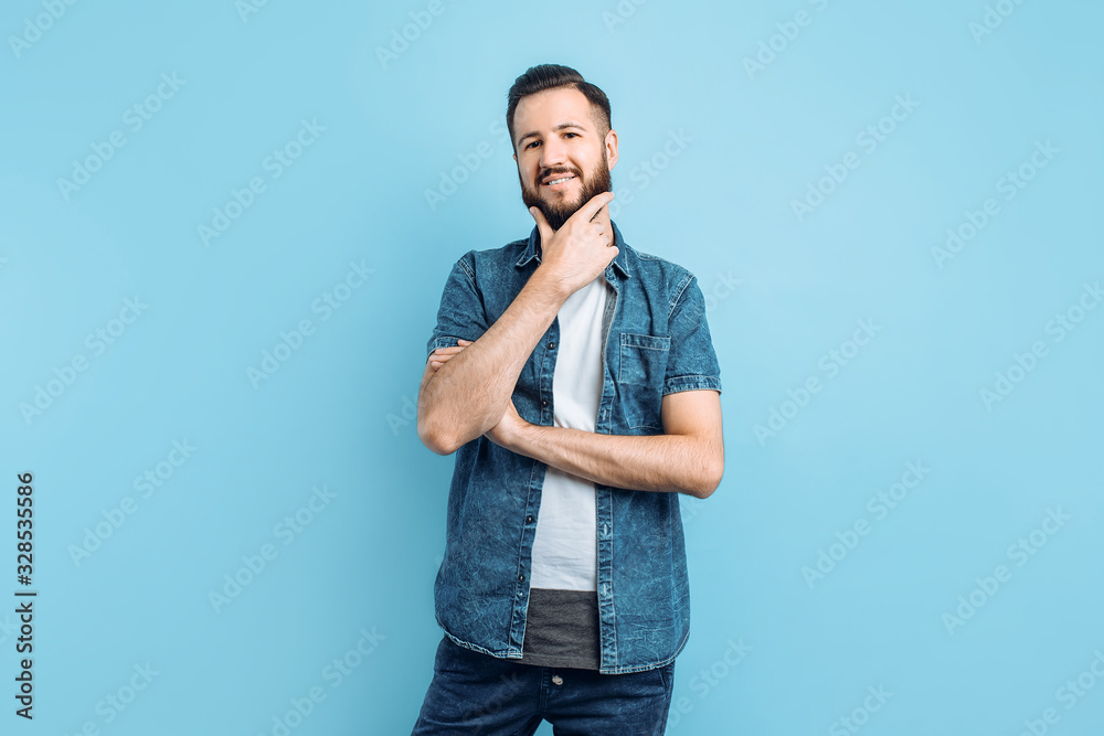 Attractive man with a beard on a blue background Attractive man with a beard on a blue background