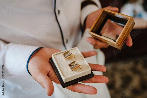Canvas Print Groom's cufflinks in a box, elegant male gold cufflinks