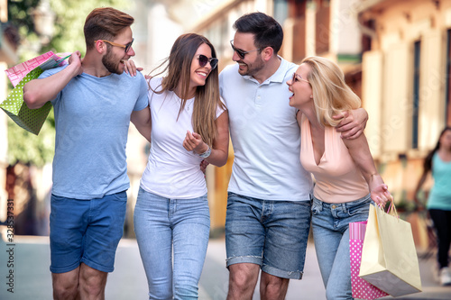 Group of young friends shopping outdoors together © ivanko80