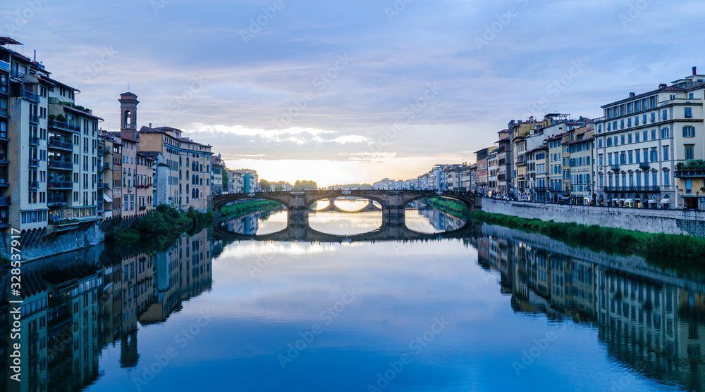 Naklejka premium Majestic view of Ponte Vecchio bridge and calm Arno river after thunderstorm in Florence Italy