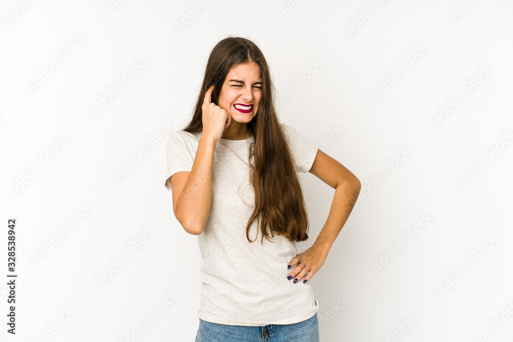 Young caucasian woman isolated on white background covering ears with hands. Young caucasian woman isolated on white background covering ears with hands.