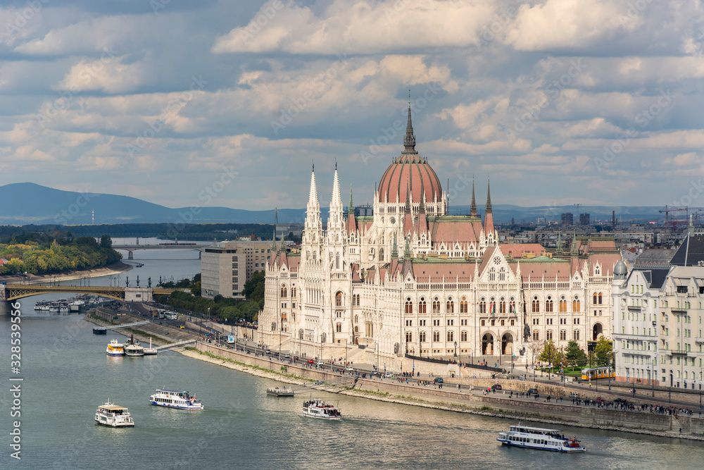 The hungarian Parliament in Budapest. Danube river. Cloudy sky. The hungarian Parliament in Budapest. Danube river. Cloudy sky.