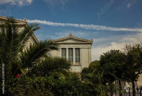antique palace facade architecture of university campus in garden park outdoor tropic environment between palms