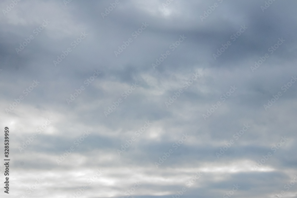 Dark gray clouds completely cover the sky in stormy weather_