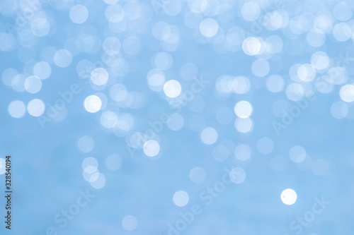 Abstract light blue background with white bokeh_