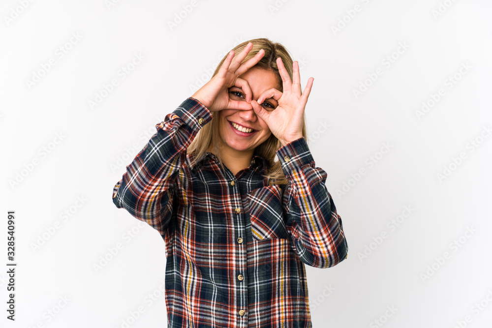 Young blonde caucasian woman isolated showing okay sign over eyes Young blonde caucasian woman isolated showing okay sign over eyes