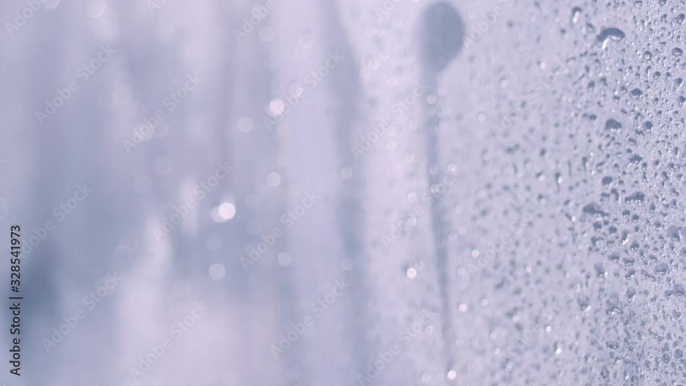 Drops of water on glass in the shower. Water flow down on glass wall in bathroom shower, Nobody. Motion 4k video, 3840x2160 footage Drops of water on glass in the shower. Water flow down on glass wall in bathroom shower, Nobody. Motion 4k video, 3840x2160 footage