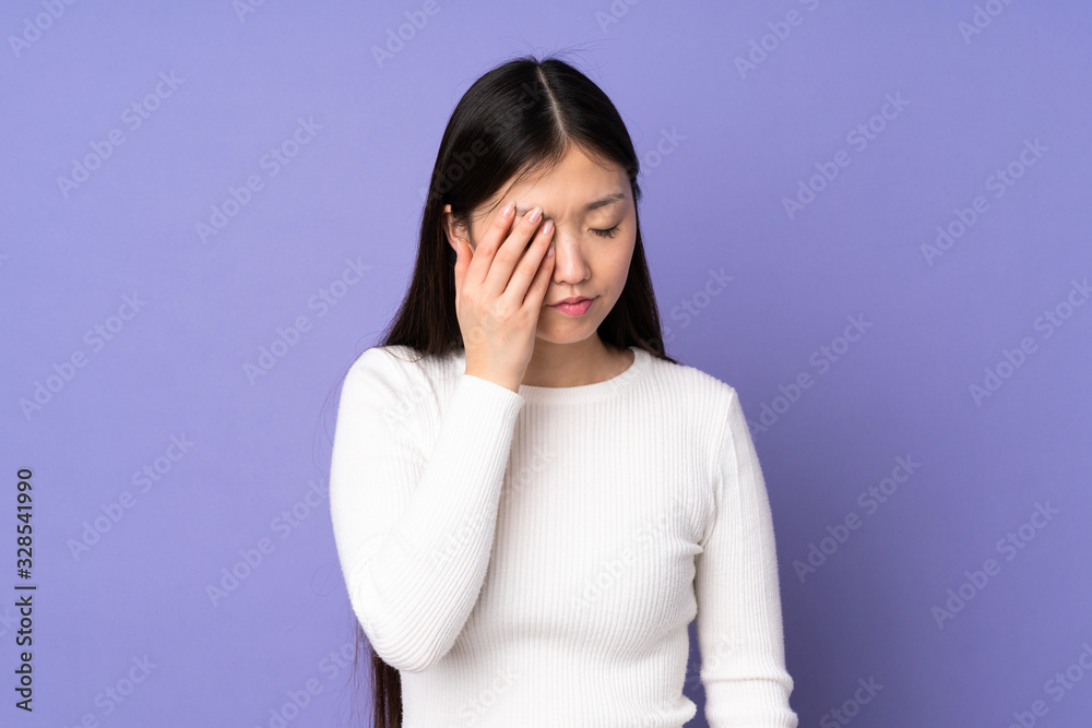 Young asian woman isolated on purple background with headache Young asian woman isolated on purple background with headache