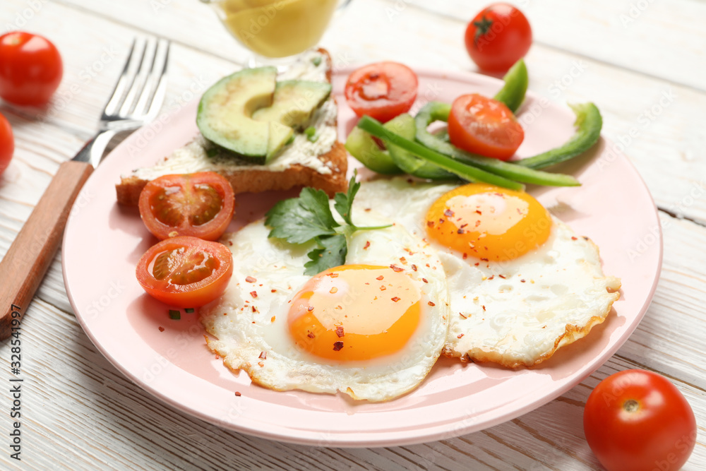 Delicious breakfast or lunch with fried eggs on wooden background, close up Delicious breakfast or lunch with fried eggs on wooden background, close up