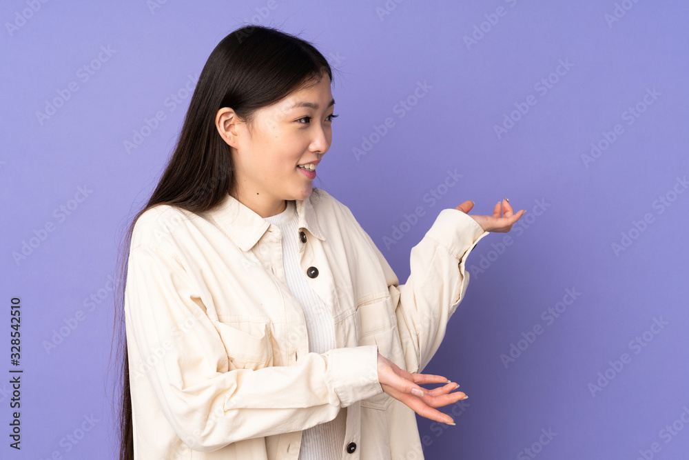 Young asian woman isolated on purple background with surprise expression while looking side Young asian woman isolated on purple background with surprise expression while looking side