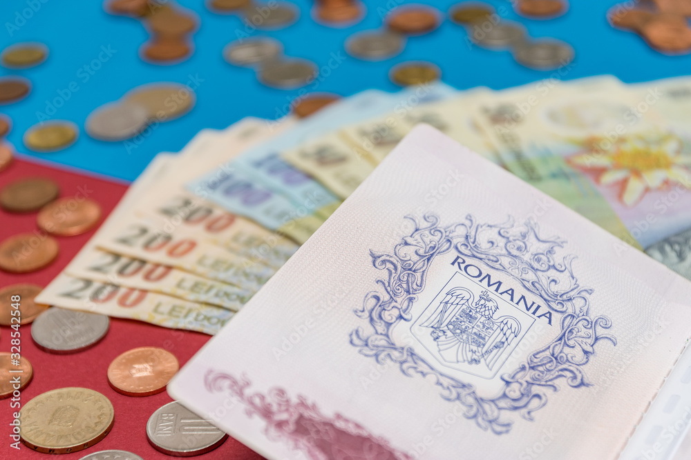 Romanian concept. The Romanian passport and Romanian banknotes/coins on a blue and red background. Coloseup of Romanian Passport and Romanian currency. Romania Finance and economy concept