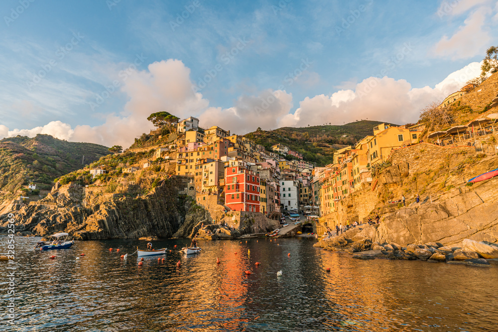 Stunning view of colorful Riomaggiore village at sunset in Cinque Terre, Italy.