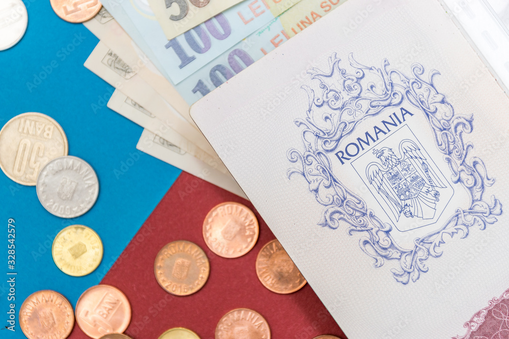Romanian concept. The Romanian passport and Romanian banknotes/coins on a blue and red background. Coloseup of Romanian Passport and Romanian currency. Romania Finance and economy concept