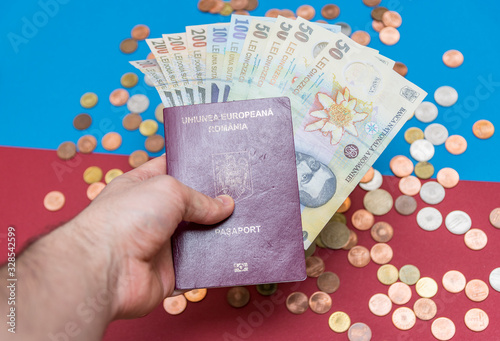 Romanian concept. The Romanian passport and Romanian banknotes/coins on a blue and red background. Coloseup of Romanian Passport and Romanian currency. Romania Finance and economy concept photo