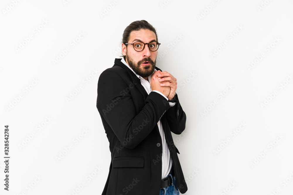 Naklejka premium Young caucasian business man isolated on a white background scared and afraid.