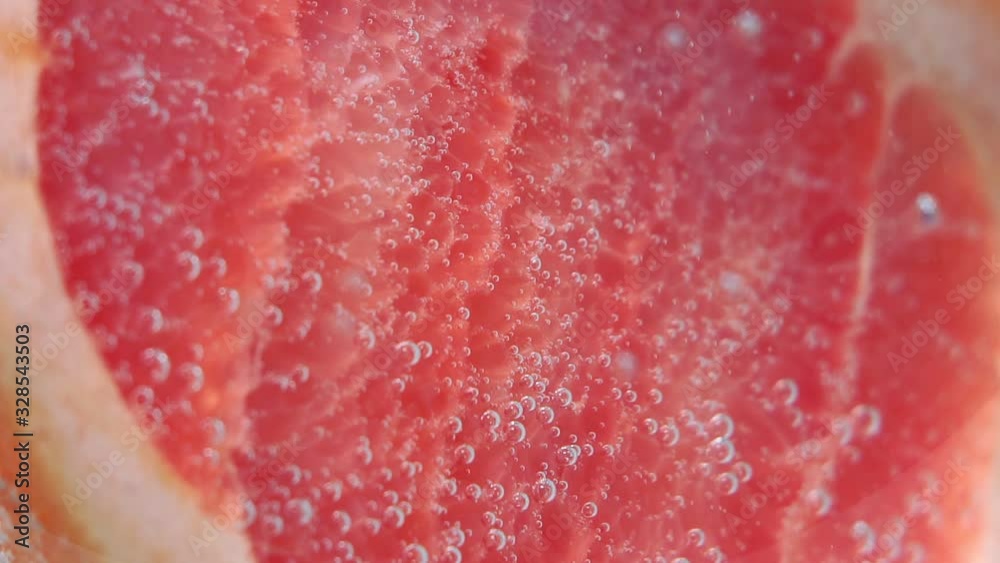 grapefruit in the macro. fresh citrus fruits in water under water. grapefruit in the macro. fresh citrus fruits in water under water.