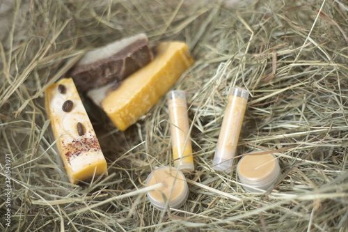 Natural cosmetic on the dry grass. Coffee beans on the soap. Hand made soaps and lip balms. Present and gifts. Natural backgropund. Heathy lifestyle